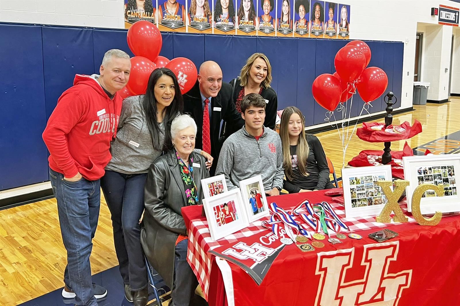 Bridgeland senior Alan Bonner, seated center, poses after signing his letters of intent to the University of Houston.